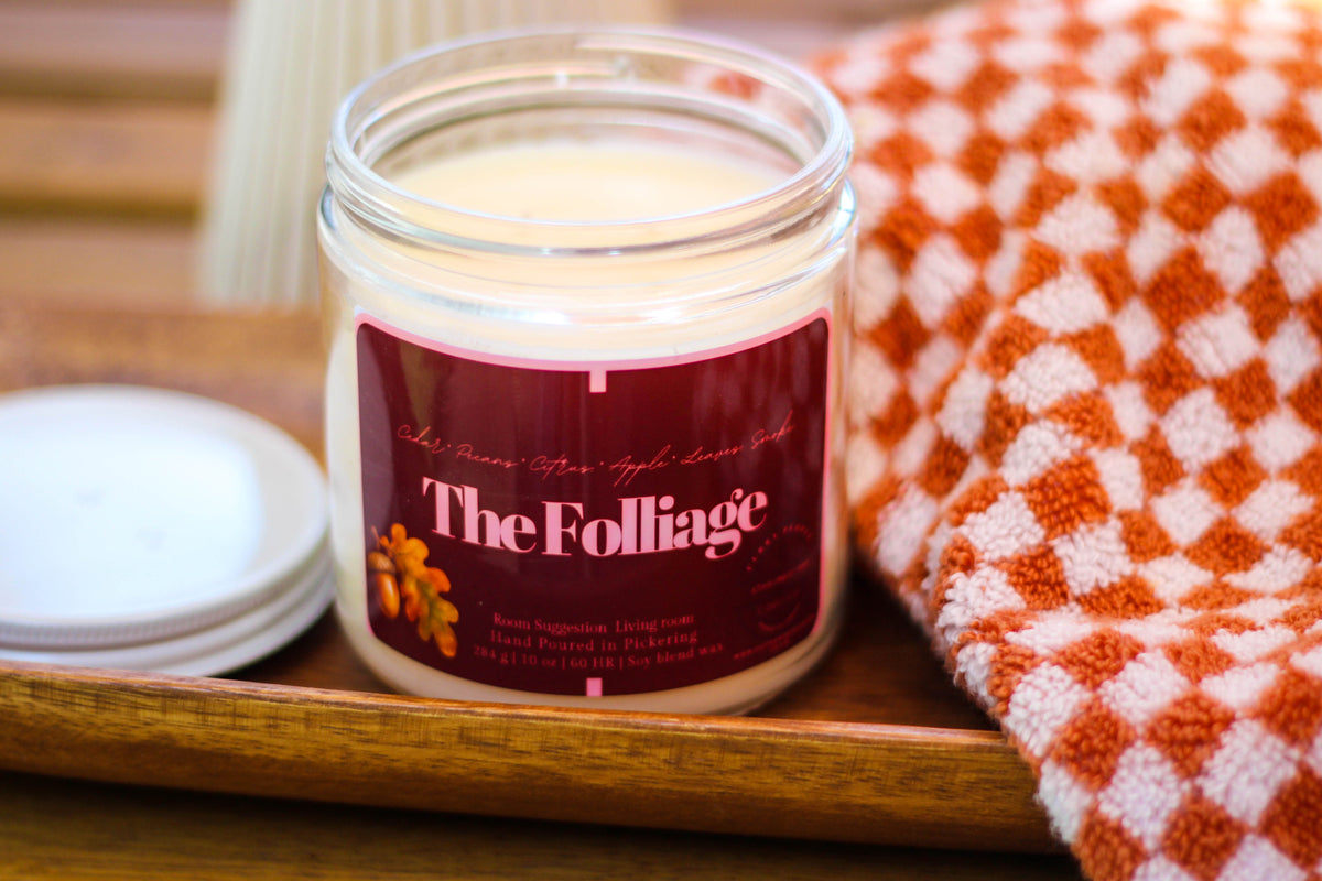 The foliage candle on top of w wooden table